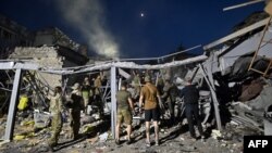 Tim penyelamat dan relawan bekerja menyelamatkan orang-orang dari bawah reruntuhan setelah serangan rudal menghantam sebuah restoran di Kramatorsk, Ukraina, 27 Juni 2023. (Foto: AFP)