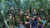 In this photo released by Colombia's Armed Forces Press Office, soldiers and Indigenous men pose for a photo with the four Indigenous brothers who were missing after a deadly plane crash, in the Solano jungle, Caqueta state, Colombia, June 9, 2023. 
