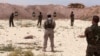 FILE - Syrian Arab trainees practice firing small arms at an undisclosed training range in northern Syria, May 21, 2016. 