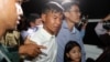 Two former Radio Free Asia reporters Oun Chhin, center, and Yeang Sothearin, right, hold together as they walk outside the main prison of Prey Sar at the outskirt of Phnom Penh, Cambodia, Tuesday, Aug. 21, 2018. Two Cambodian journalists who had worked for U.S.-funded Radio Free Asia and are charged with espionage have been released on bail, a day after a pardon freed four land rights activists from prison. (AP Photo/Heng Sinith)