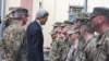 FILE - Secretary of State Kerry greets U.S. troops outside Resolute Support Headquarters following a meeting with General "Mick" Nicholson, commander of U.S. forces in Afghanistan, April 9, 2016. (P. Dockins/VOA)