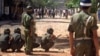 FILE PHOTO - Riot policemen protect themselves with shields as anti-government protesters throw rocks during a clash near the U.S. Embassy in Phnom Penh Wednesday, Sept. 9, 1998. Defiant opposition leaders vowed Wednesday to intensify mass protests against Cambodian leader Hun Sen, even as riot police used guns, clubs, cattle prods and water cannons to scatter rock-throwing demonstrators demanding his ouster. Police dispersed about 1,000 protesters after clashes near the U.S. Embassy and nearby residence of opposition leader Prince Norodom Ranariddh. Some regrouped later in smaller clusters around the city. (AP Photo/Ou Neakiry)
