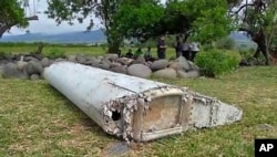 FILE - This image taken from video, shows a piece of debris from a plane, July 29, 2015, in Saint-Andre, Reunion.