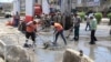 FILE - Municipality workers clean up debris in the aftermath of a bomb attack in Baghdad northern Shaab district, Iraq, May 30, 2016. 