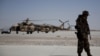 FILE - A NATO soldier stands guard under the wing of a C-130 Hercules aircraft, that belongs to the Afghan National Army, in Kandahar Air Field, Afghanistan, Aug. 18, 2015. 