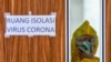 Seorang petugas medis mengenakan pakaian pelindung melihat dari jendela ruang isolasi Rumah Sakit Undata di Palu, Sulawesi Tengah, 1 Februari 2020. (Foto: AFP)