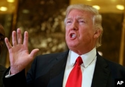FILE - Donald Trump, president-elect at the time, speaks with reporters in the lobby of Trump Tower in New York, Jan. 13, 2017. In a tweet earlier this month, Trump accused former president Barack Obama of wiretapping his offices in the Manhattan skyscraper.