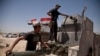 Iraqi counterterrorism forces load a Humvee with rockets to take to a front line position in their fight to oust Islamic State militants from Fallujah, Iraq, June 7, 2016.