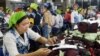 FILE PHOTO - Cambodian garment workers work inside a factory in Phnom Penh, Cambodia, May 10, 2004. 