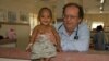 Dr. Beat Richner holds a baby at Kantha Bopha children hospital, in Phnom Penh, Cambodia. (Courtesy photo) 